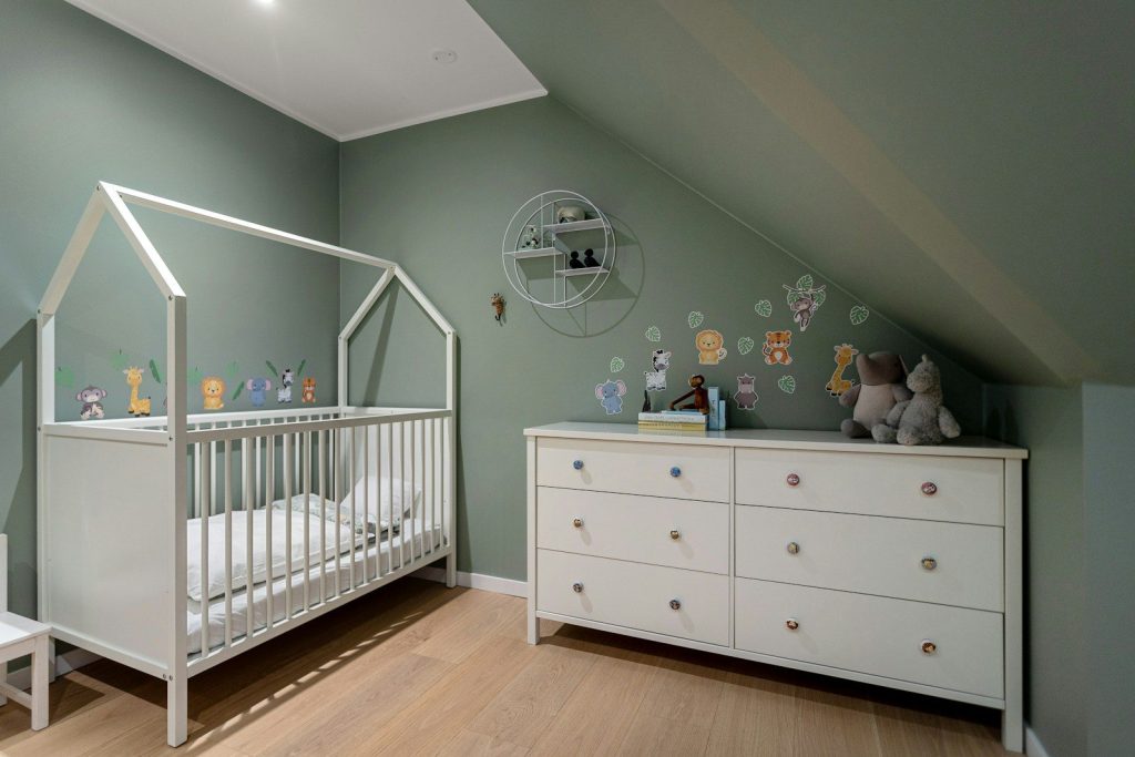 A baby's room with a crib and dresser
